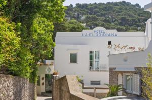 a white building with a sign that reads river laderaalam at Hotel La Floridiana in Capri