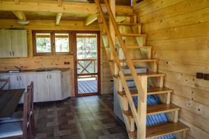 a wooden cabin with a spiral staircase in it at Gościniec Echo in Piecki