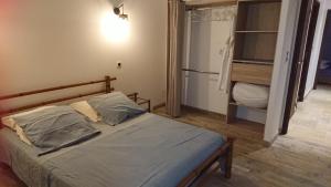 a bedroom with a bed and a refrigerator at LOCANOMA in Corbara