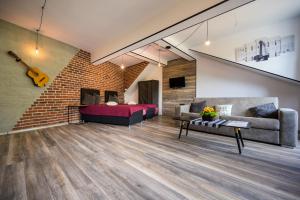 a living room with a couch and a guitar at Urban Music Studio byPMM in Plovdiv