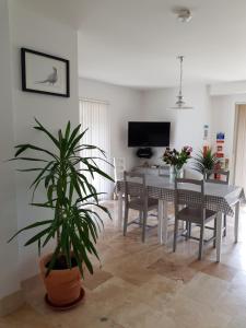 a living room with a table and a dining room at Tirah Guest House in Aldeburgh