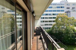 a balcony with a view of a building at George Apartment in Neuilly in Neuilly-sur-Seine