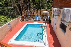 a small swimming pool on a patio next to a house at Caribbean Dream Vacation Property CD2 in Rodney Bay Village