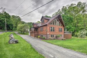a large wooden house on a road at Lake View and Hot Tub Wrightsville Cabin! in Wrightsville