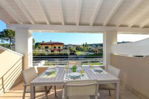 a dining table on the balcony of a house at Villa Meri Star in Manerba del Garda