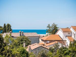 a group of houses with the ocean in the background at Apartments Špadići in Poreč