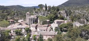 a village on the side of a mountain at Grand Studio Entre Lac Et Garrigue in Clermont-lʼHérault
