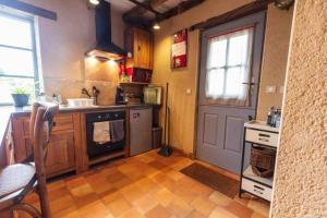 a kitchen with a sink and a stove at Longère Touraine Anjou in Hommes