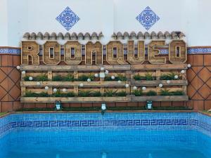 a swimming pool with a sign that readsulum at ROOMQUEO-Only Adults in Barbate