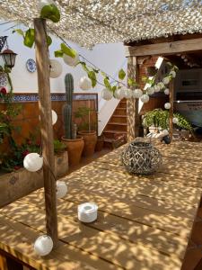 a patio with a table with cactuses and plants at ROOMQUEO-Only Adults in Barbate