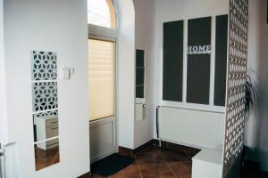 a bathroom with a toilet and a window and a mirror at Rákóczi apartman in Odorheiu Secuiesc