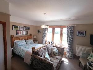 a bedroom with a bed and a couch at Hay Farm House in Ford