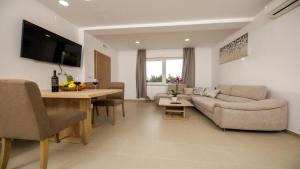a living room with a couch and a table at Apartments Mi&Ni in Cavtat +37 photos