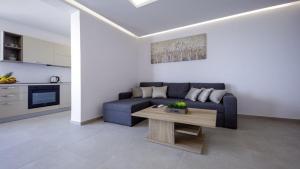 a living room with a blue couch and a table at Apartments Mi&Ni in Cavtat