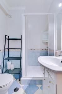 a bathroom with a sink and a toilet at LA CASA DEL MAR in Olhão +25 photos