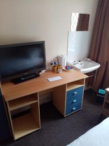 a television on a desk in a hotel room at Black Lion in Scarborough