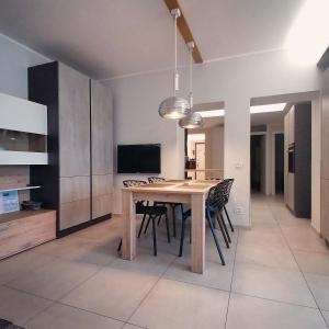 a dining room with a wooden table and chairs at Bellavista Eremitaggio in Torri del Benaco