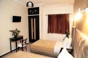 a hotel room with a bed and a table and a chair at Kasba TanTan in Tan-Tan Plage