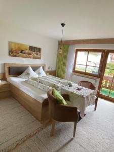 a bedroom with a bed and a table and a window at Gästehaus Waltraud in Längenfeld