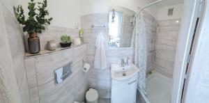 a white bathroom with a sink and a toilet at Gdańsk in Gdańsk