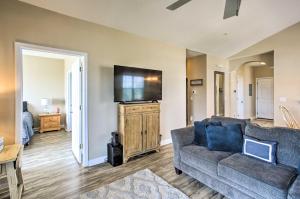 a living room with a couch and a flat screen tv at North Myrtle Beach Condo with Private Balcony! in Myrtle Beach