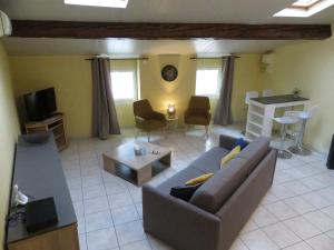 a living room with a couch and a table at Au Bonheur Suspendu in Pont-en-Royans