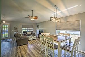 a dining room and living room with a table and chairs at Modern Beach Retreat with Pool, Hot Tub, and Patio! in Fort Myers