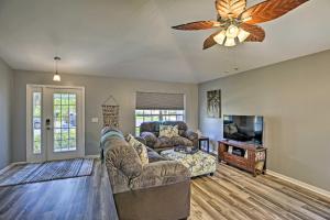 a living room with a couch and a ceiling fan at Modern Beach Retreat with Pool, Hot Tub, and Patio! in Fort Myers