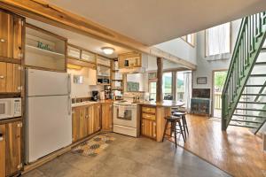 een keuken met houten kasten en een witte koelkast bij Cozy-Chic Abode Hang Glide, Hike, Rock Climb in Trenton