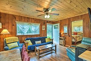 a living room with wooden walls and a ceiling at Day Trips to Boyne Mtn! Cabin Near Lake Charlevoix in Charlevoix