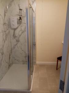 a shower with a glass door in a bathroom at Black Lion in Scarborough +20 photos