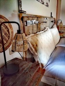 a bedroom with a bed and a table with a lamp at Podere Montecorno in Alberese