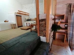 a room with a brick wall and a room with a bed at La Fortance Paradis Naturel - Proche de la ville in Planfoy