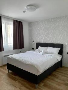 Zlatna Kruna - Lux Apartments Kopaonik في كوباونيك: غرفة نوم بسرير كبير مع ملاءات بيضاء +22 صورة