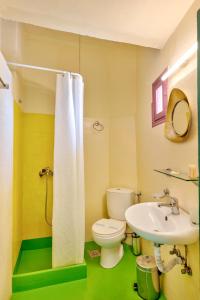 a bathroom with a white toilet and a sink at Boutique Florence in Ermoupoli +22 photos