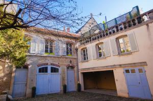 an old house with blue doors and a garage at La Terrasse in Dijon