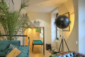 a living room with a couch and a pool table at La Terrasse in Dijon