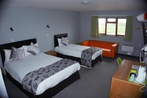 Säng eller sängar i ett rum på Happy Guests Lodge