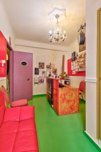 a living room with a red couch and a green floor at Boutique Florence in Ermoupoli