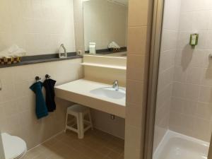 a bathroom with a sink and a toilet and a mirror at GOOD Times Gerlitzen in Deutschberg +18 photos