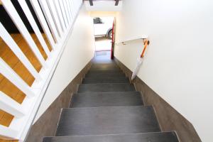 a stairwell in a house with black carpet and white walls at Casa do Tablado - Foz Côa in Vila Nova de Foz Coa
