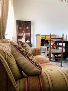 a living room with a couch with pillows on it at Casa Zi' Peppe in Capranica +23 photos