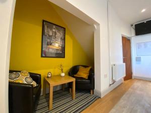 a living room with a couch and a table at 77 Underwood Lane in Crewe