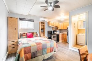 a bedroom with a bed with a colorful blanket at Bayside Cottage Rentals in Port Rowan