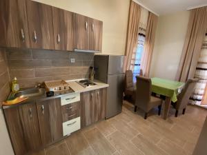 a small kitchen with a sink and a table with a tablektop at Apartments Zlatko in Soko Banja