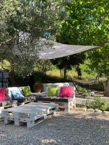 a patio with couches and a table and an umbrella at Sevastie’s home in Samothráki