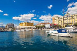 a boat is docked in the water in a harbor at Apartment Vintasio in Rijeka