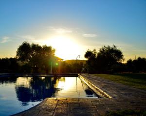 a sun setting over a body of water at Cortijo Mesa de la Plata in Arcos de la Frontera