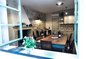 a dining room with a table and a fireplace at Casa Arancin in Poreč