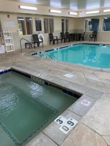 a large swimming pool in a hotel room at Sleep Inn and Suites Davenport in Bettendorf